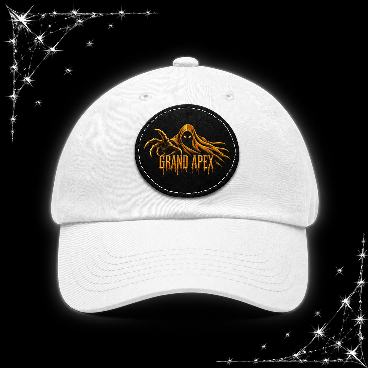 A white baseball cap with a circular black patch on the front featuring a gold spider graphic and the text 'GRAND APEX'. The cap is centered against a black background with chrome webbing graphics in the corners.