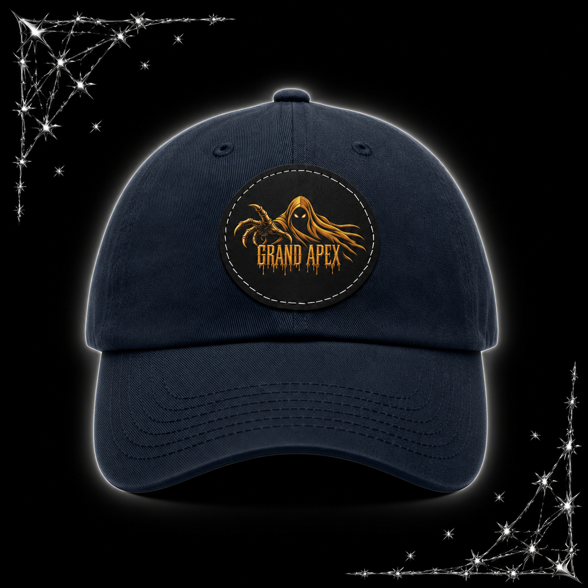 A navy blue baseball cap with a circular embroidered patch on the front featuring a golden tentacle logo and the text 'GRAND APEX'. The cap is centered against a black background with chrome webbing in the corners.