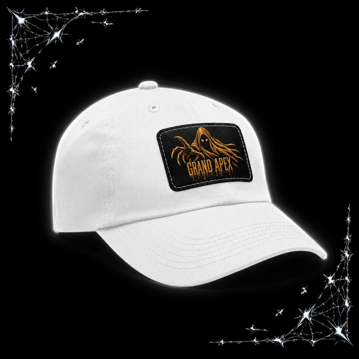 A white baseball cap with a black rectangular patch on the front featuring a golden hooded figure and the text 'GRAND APEX'. The cap is displayed against a black background with chrome webbing graphics in the corners.