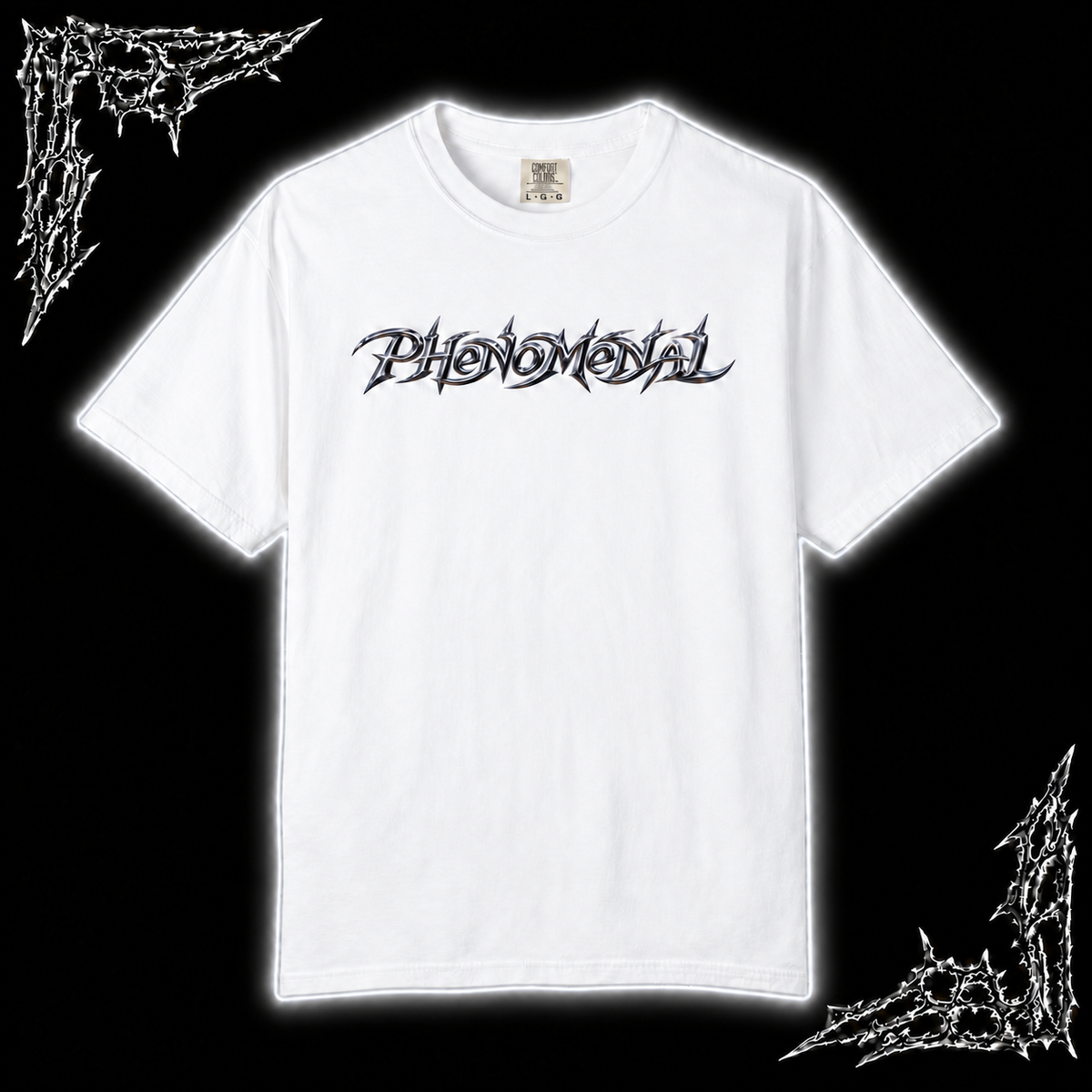 A white short-sleeve t-shirt with a black stylized gothic font graphic reading 'Phenomenal' across the chest, displayed against a black background with white barbed wire corner designs.